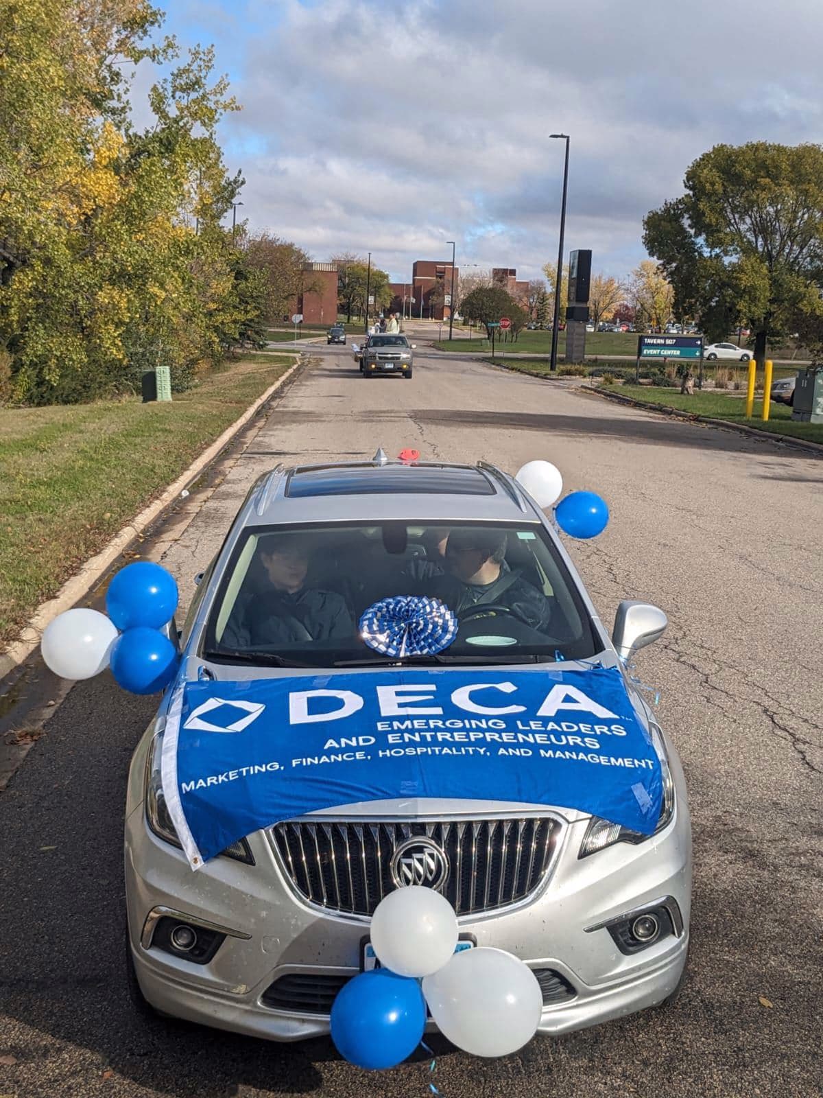 SMSU DECA parade car with chapter banner at a community event